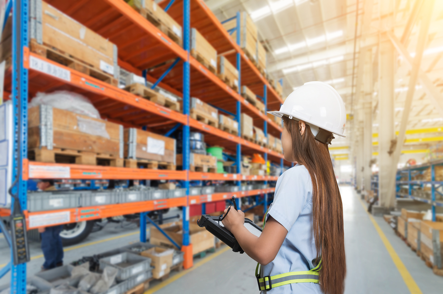 a female worker conducting a pallet racking inspection in London