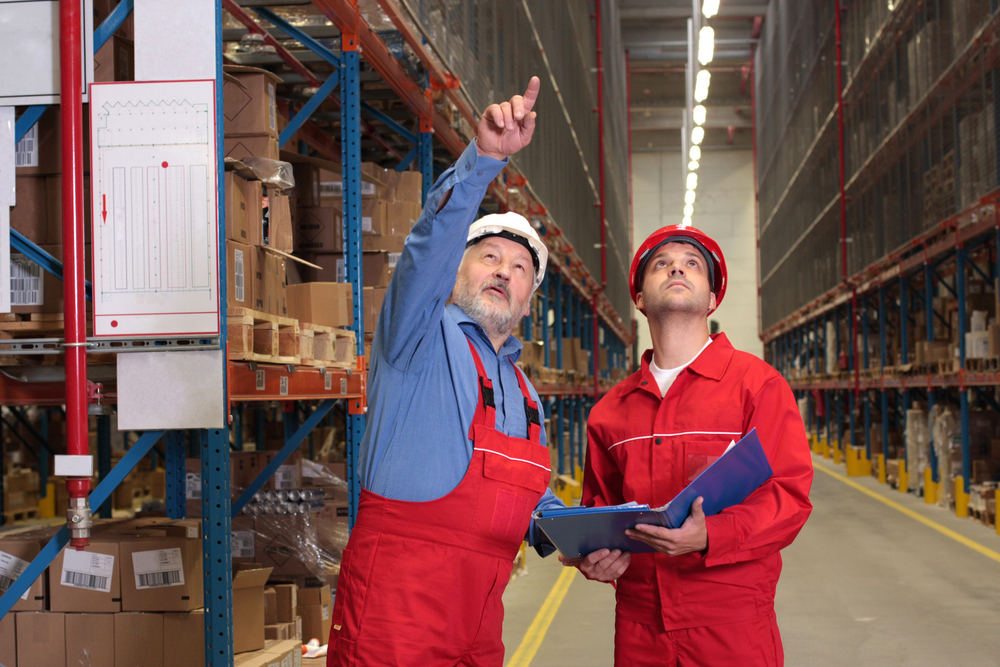 A SEMA approved inspector pointing to warehouse racking